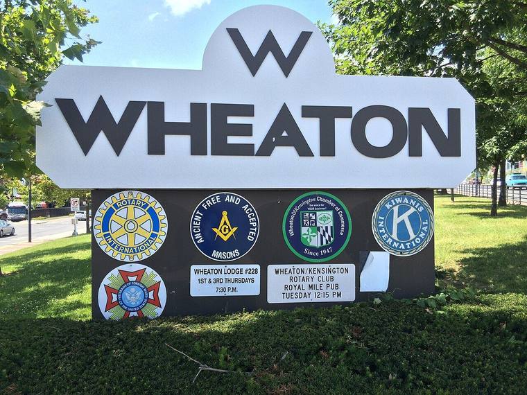 A welcome sign marking the entrance to downtown Wheaton